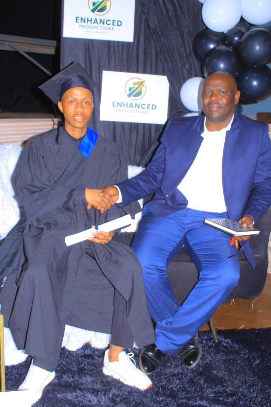 A graduate shaking hands during a certificate presentation